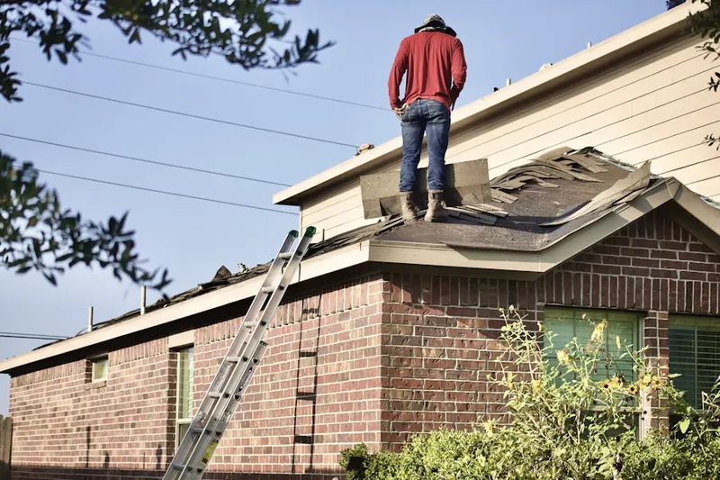 Professional roofer working on a residential roof in Park Meadows
